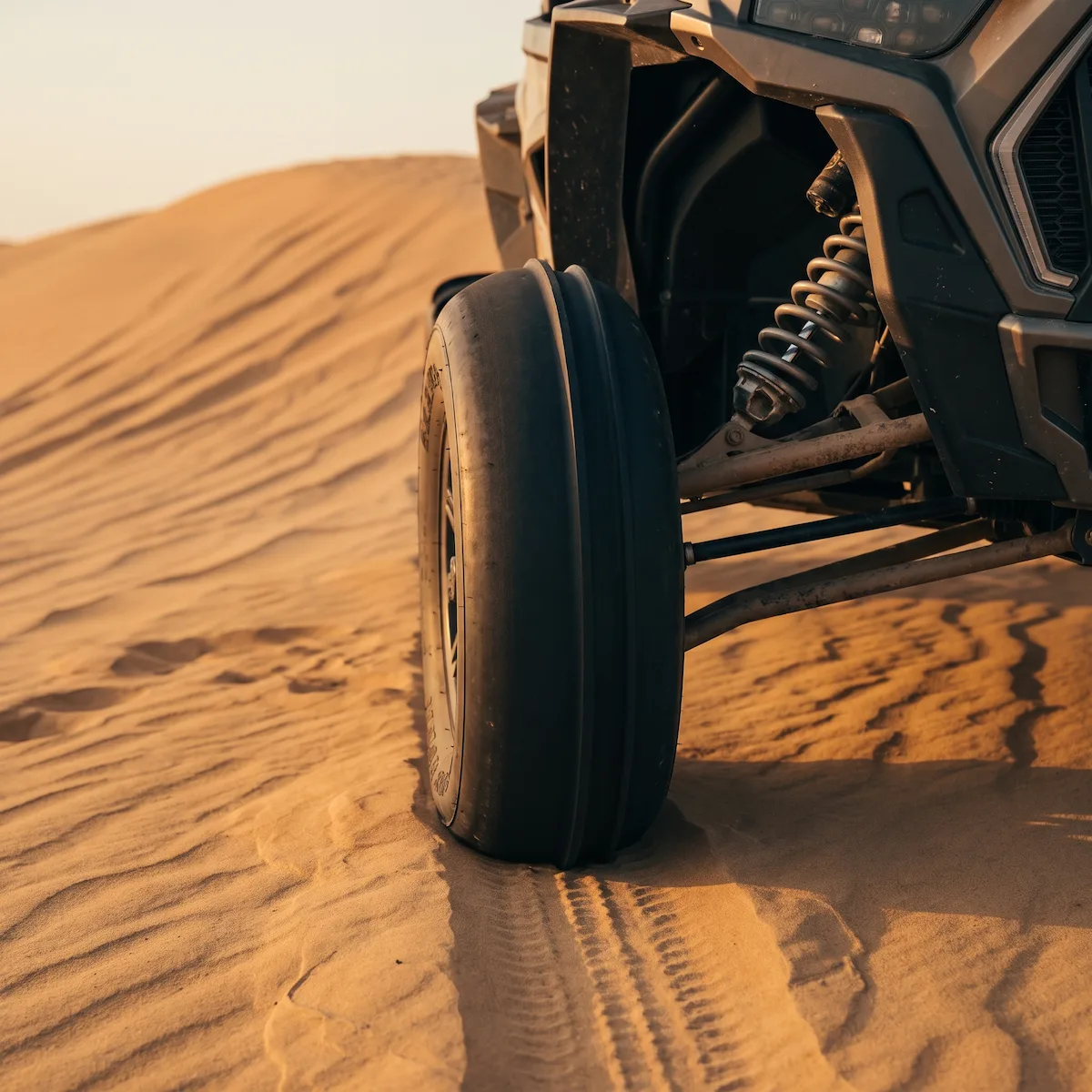 INVICTA SAND KING PRO front sand tire with its raised center steering rib parked on a dune